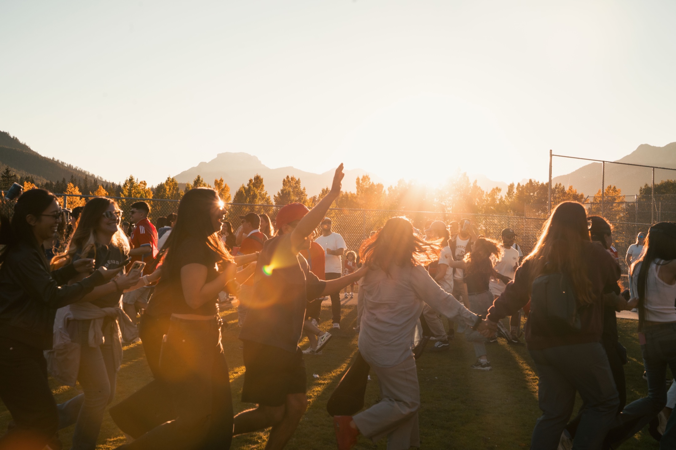 Festival guests dancing at sunset in the Bow Valley